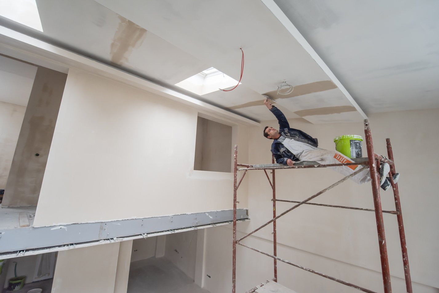 Construction Worker Plastering on Gypsum Ceiling